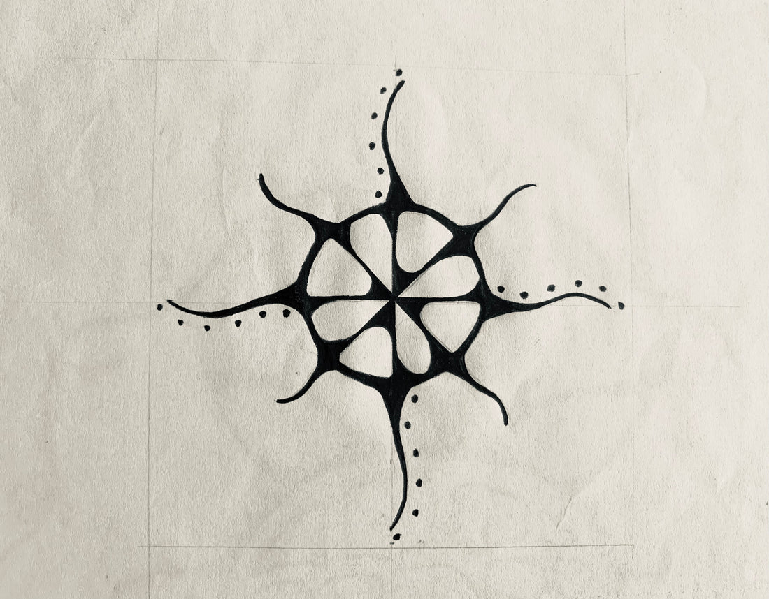A pencil drawing of a stylized Indigenous sun motif divided into quadrants with the rays radiating away from the core