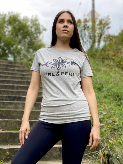 A woman standing on outdoor stairs wearing a heather grey t-shirt with stylized flowers and "Pre&Peri" printed on it in black ink