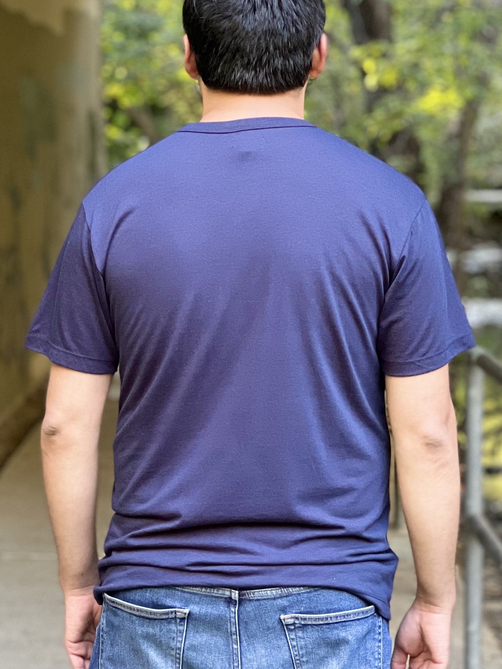 Back view of a man wearing a midnight blue t-shirt