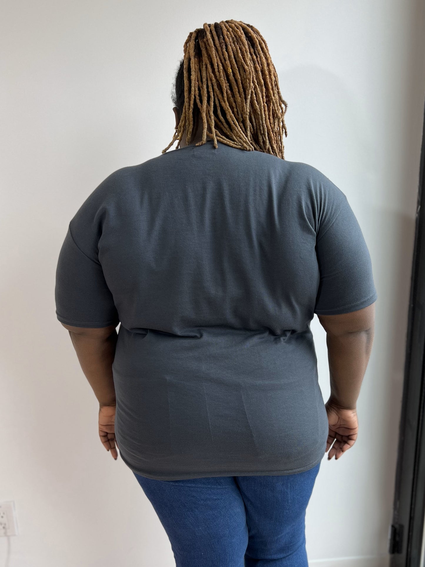 Back view of a woman wearing a charcoal t-shirt