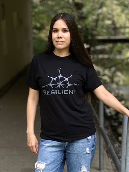 A woman wearing a black t-shirt with the word "Resilient" under a stylized rising sun