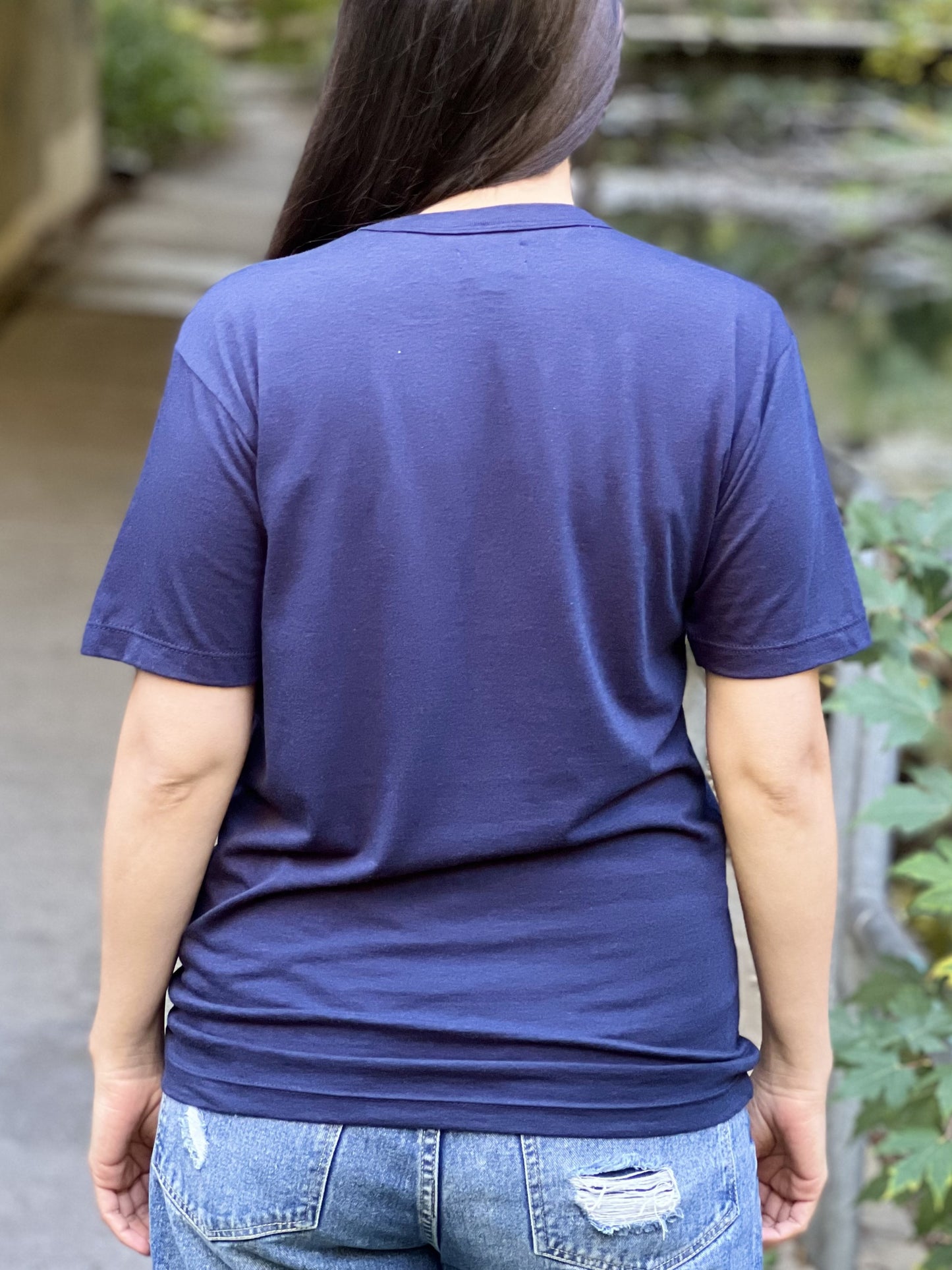 Back view of a woman wearing a midnight blue t-shirt