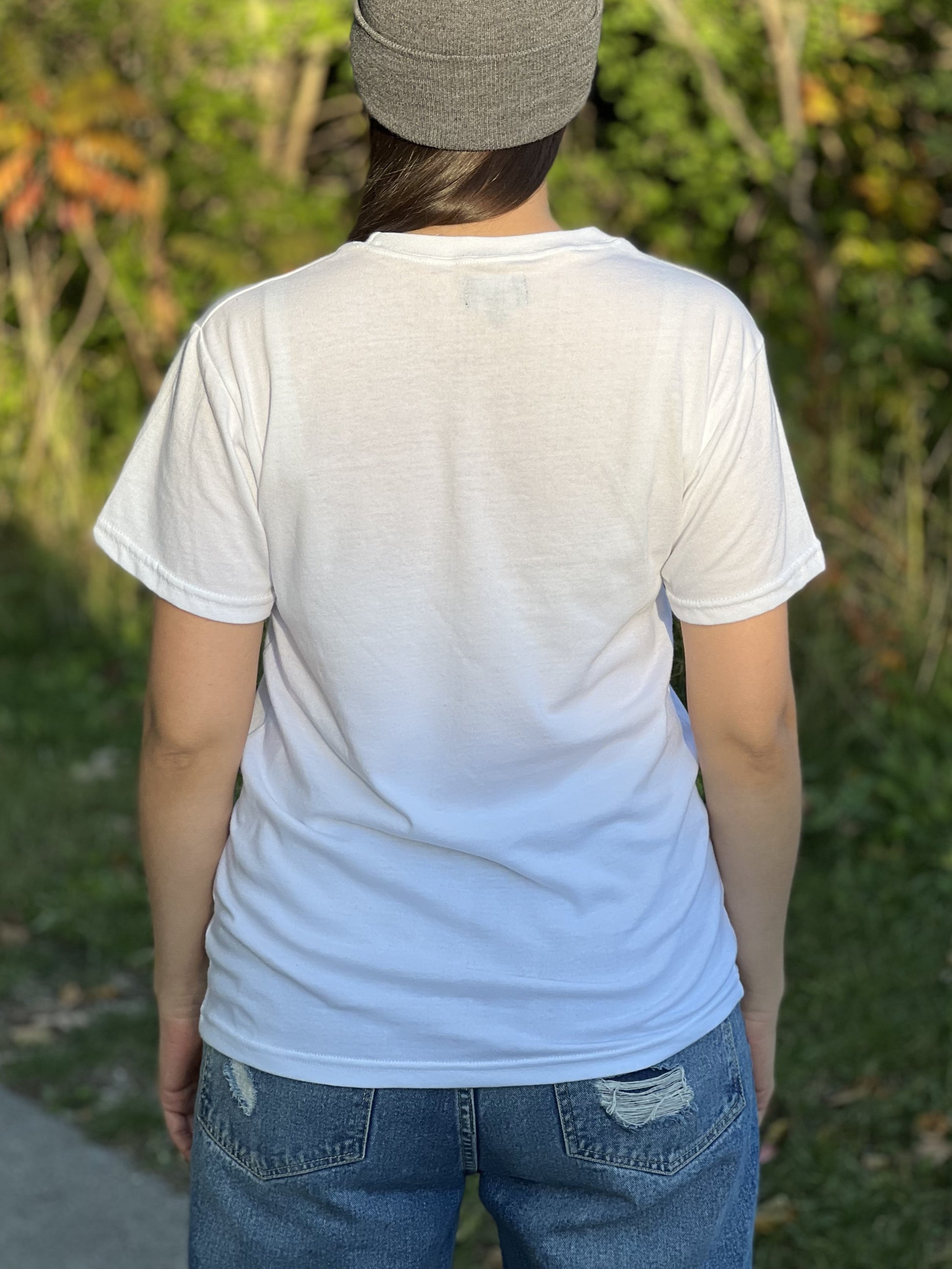 Back view of a woman wearing a white t-shirt.